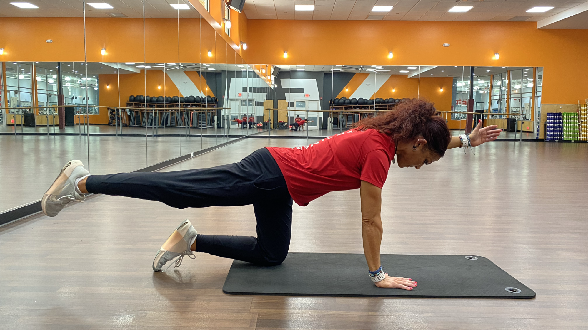 woman does core exercise on mat