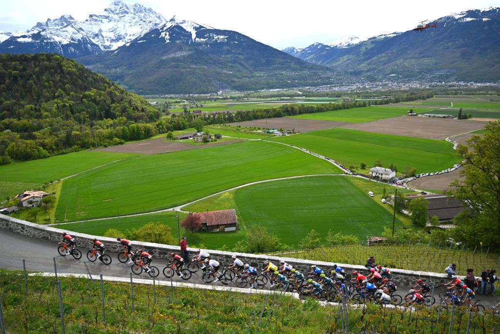 LEYSIN SWITZERLAND APRIL 27 Egan Bernal of Colombia Carlos Rodriguez of Spain and Team INEOS Grenadiers Juan Ayuso of Spain and UAE Team Emirates Yellow Leader Jersey Ilan Van Wilder of Belgium and Team Soudal QuickStep White Best Young Rider Jersey and a general view of the peloton passing Aigle village 405m during the 77th Tour De Romandie 2024 Stage 4 a 1592km stage from Saillon to Leysin 1314m UCIWT on April 27 2024 in Leysin Switzerland Photo by Luc ClaessenGetty Images