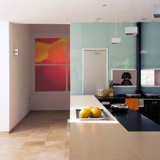 kitchen with painting on wall wooden counter and cream colour tiles floor