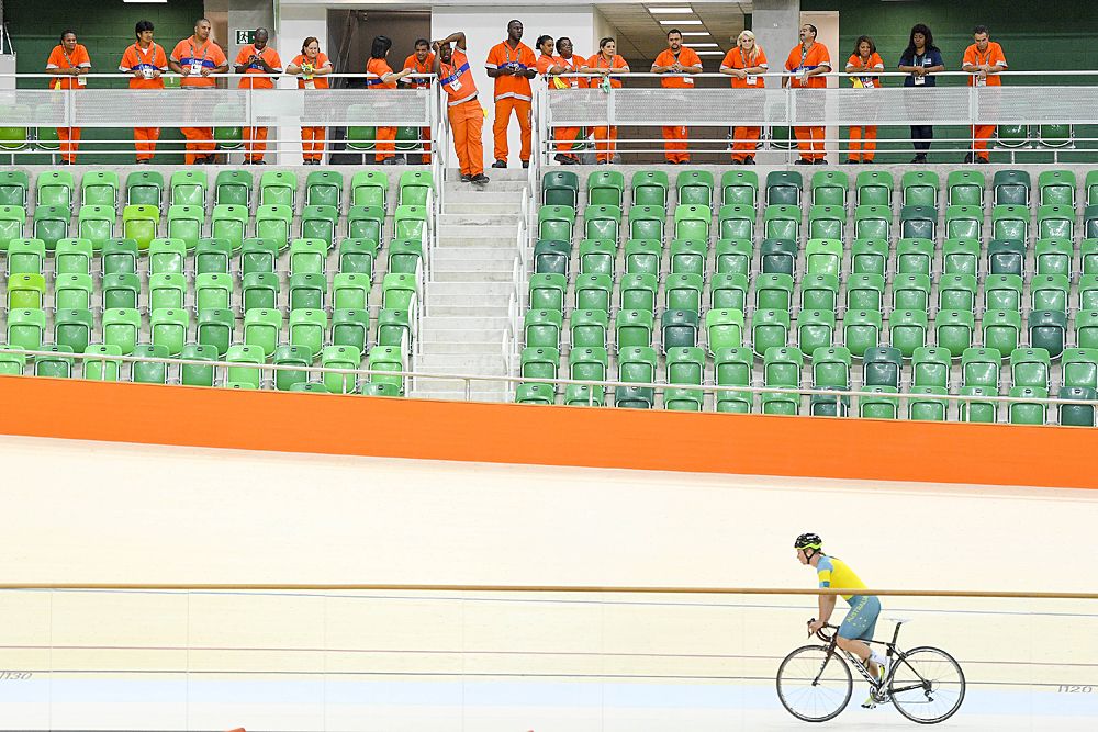 Works watch the track training session at the Olympic Games