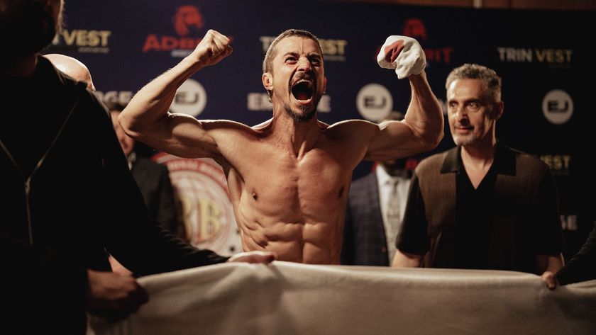 Orlando Bloom flexing his muscles during weigh in as “Boxer” and John Turturro as “Boz” in the Psychological Thriller film, THE CUT