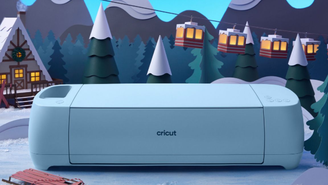 Cricut Christmas ideas; a photo of a Cricut Maker 3 in front of a Christmas scene