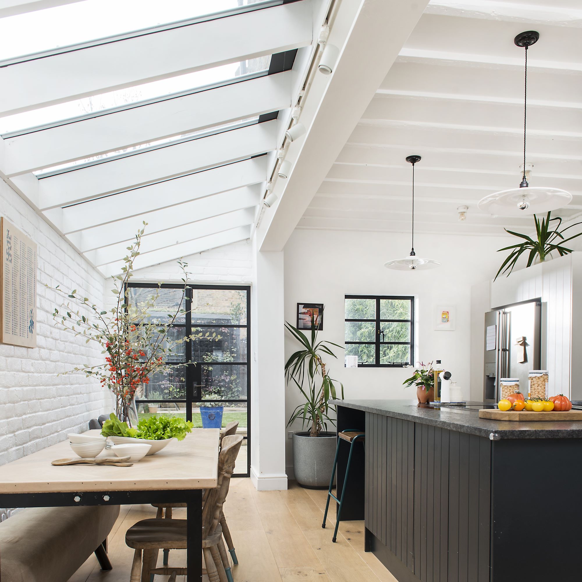 Large kitchen and dining area with half skylight roof