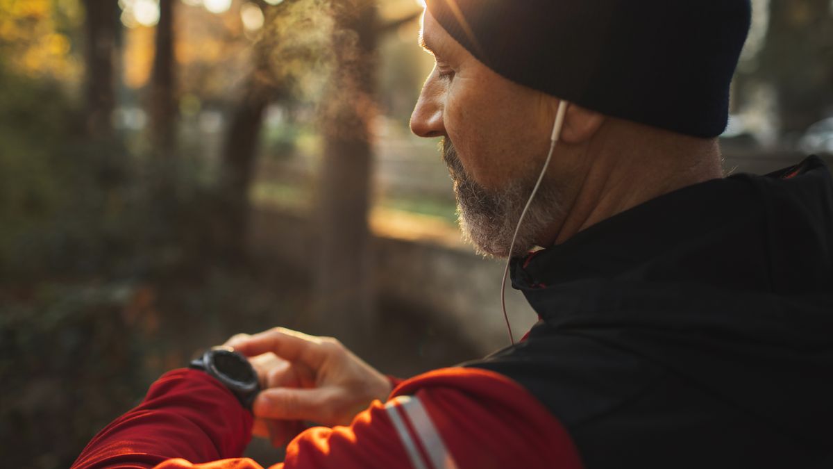 Man checking sports watch during run