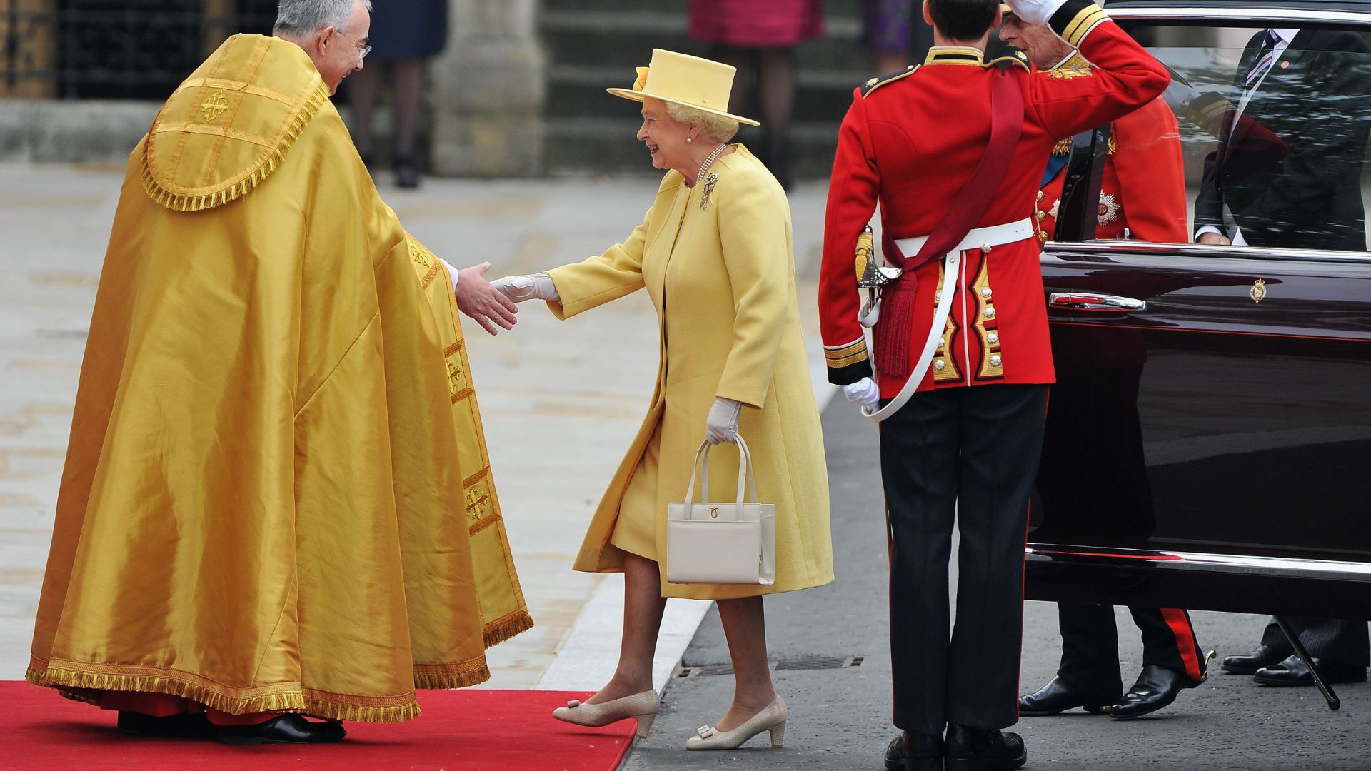Queen Elizabeth II greeting a priest