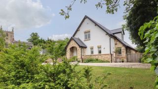 self build property with brick and rendered finish with slate tiled roof and porch set in a semi-rural location