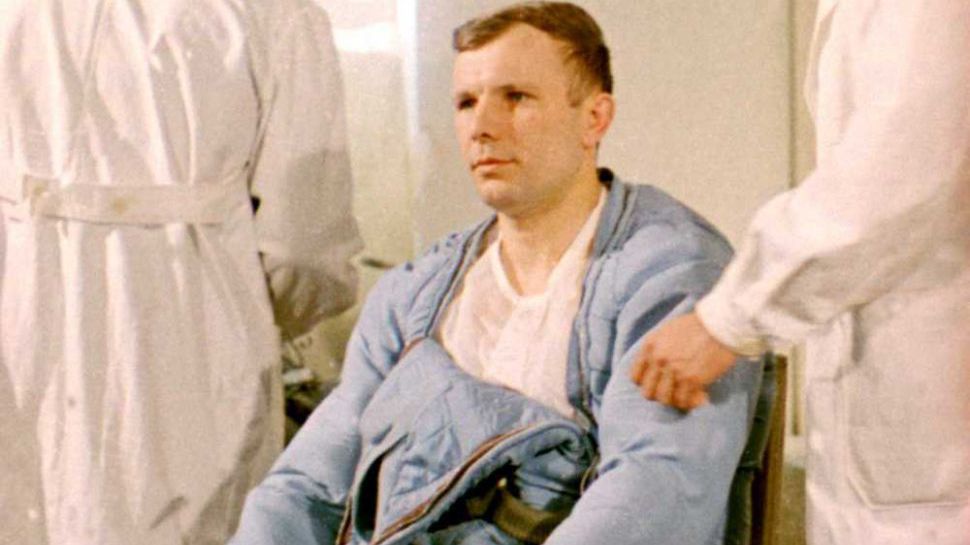 Yuri Gagarin seen dressing in a heating/cooling garment worn under his orange pressure suit.