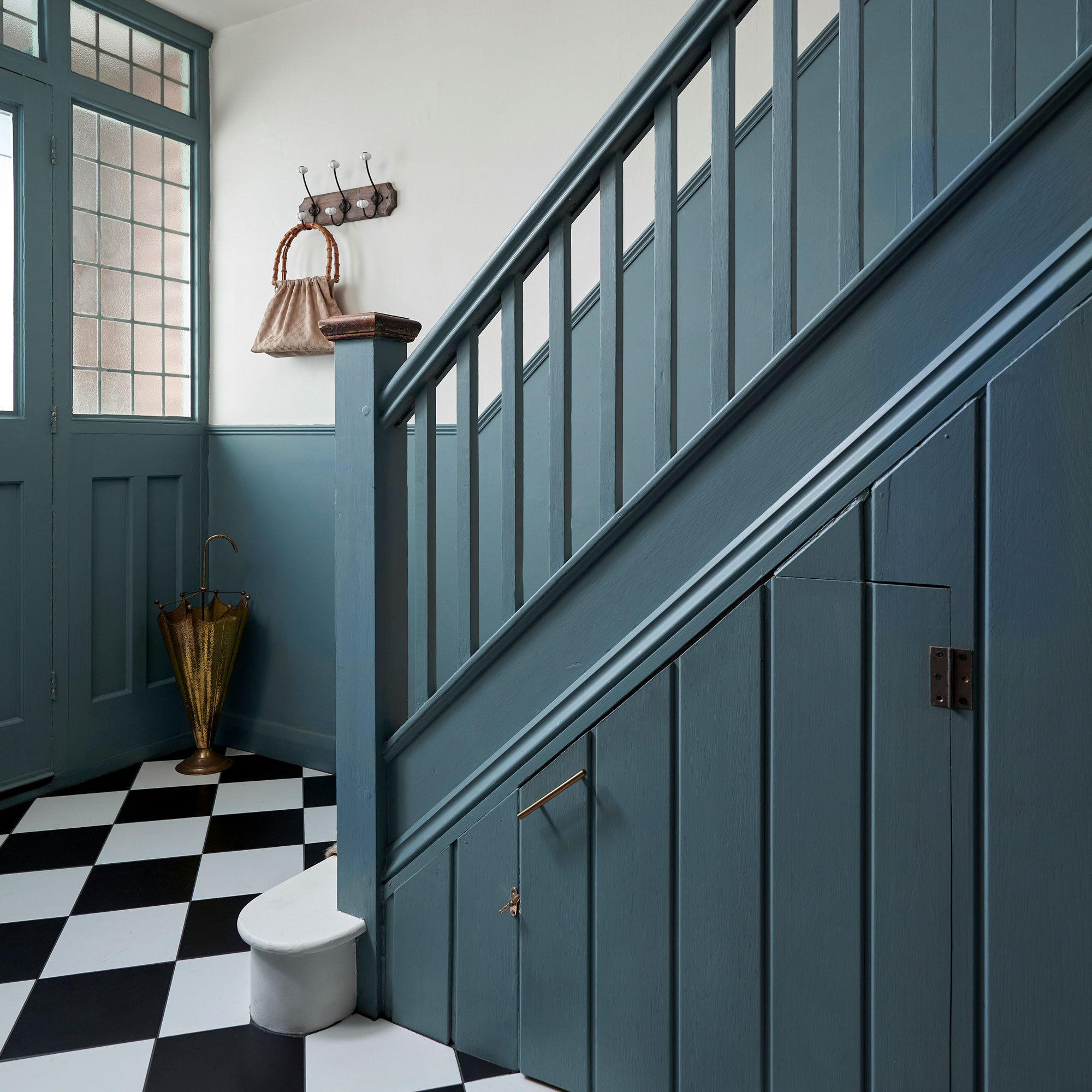 Navy blue hallway with black and white flooring
