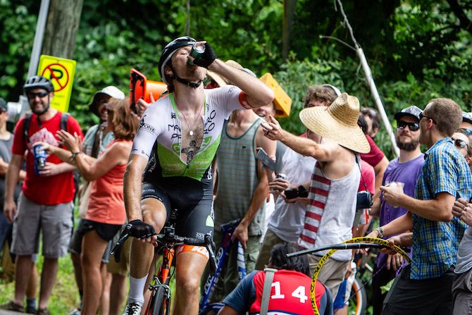 A rider takes a hand up from fans during today's hot US Pro Road Race National Championships on June 24, 2018 in Knoxville, Tennessee