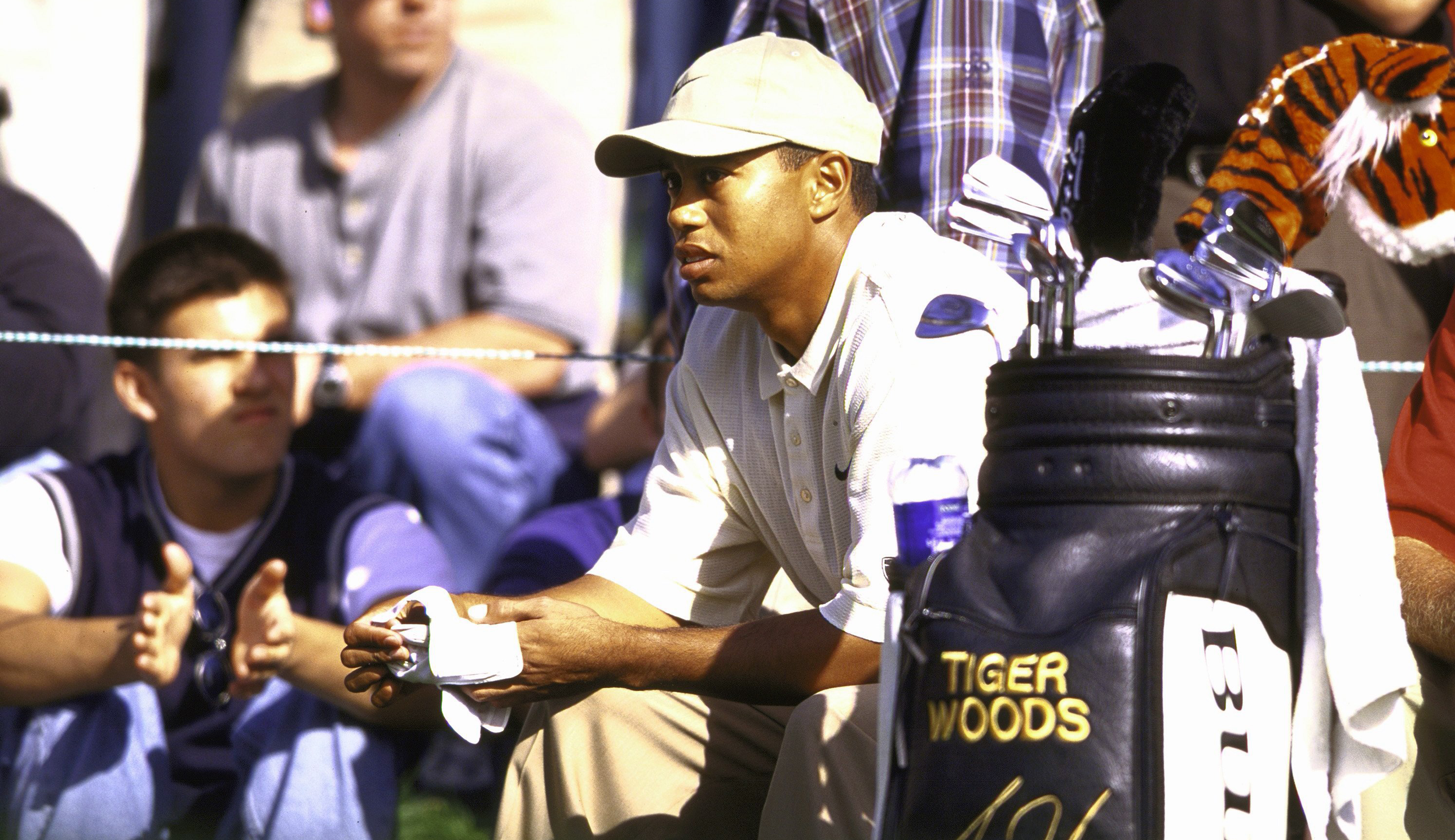 Tiger Woods sits by his golf bag