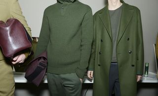 Two male models wearing matching green outfits