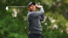 Tiger Woods of the United States plays his shot from the fourth tee during a practice round prior to the 2024 Masters Tournament at Augusta National Golf Club on April 09, 2024 