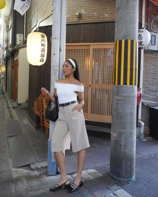 Shorts trends 2024: @jeannine.roxas wears long beige bermuda shorts with a white off the shoulder top