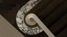 a single Calcutta viola step on a dark walnut staircase with a curved handrail