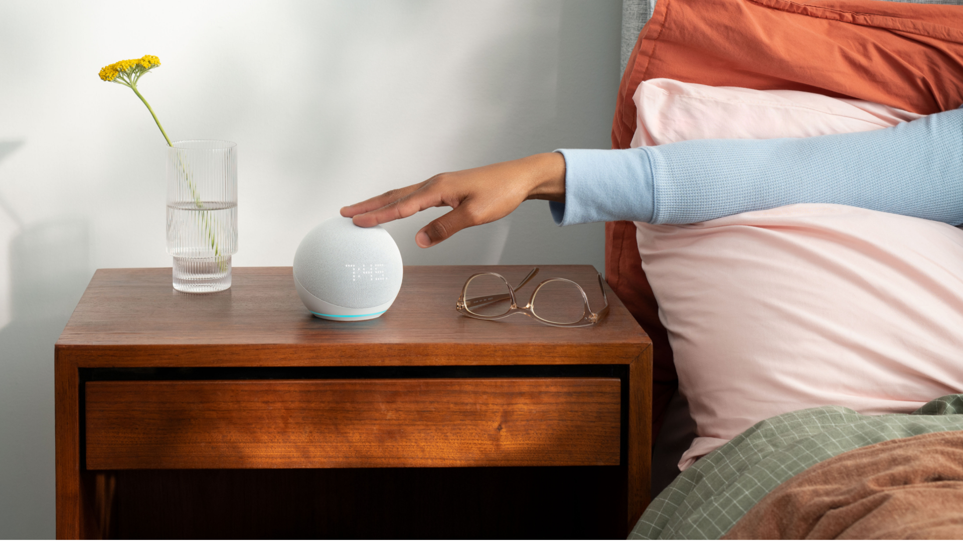 Echo dot with the clock beside the bed