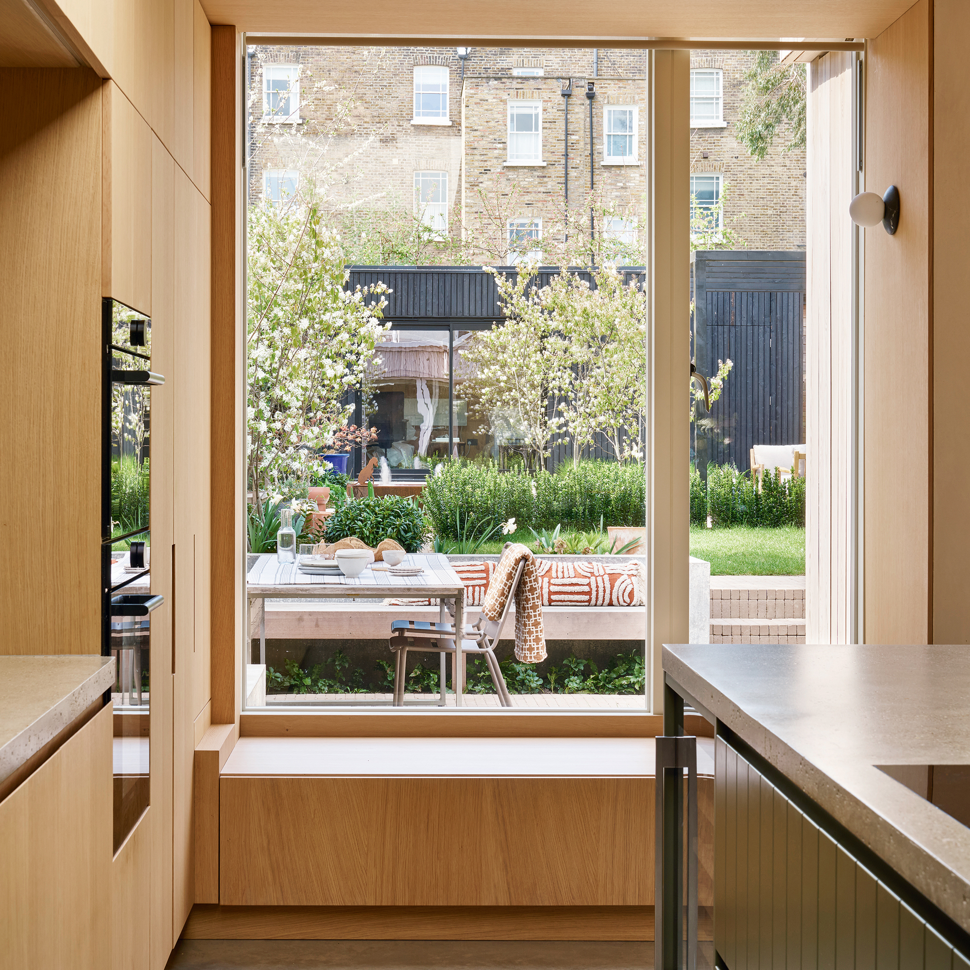 view from a kitchen out into a large garden via a large picture window