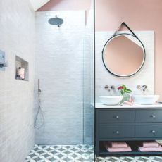 Bathroom with walk-in tiled shower, next to a sink area and a mirror above it