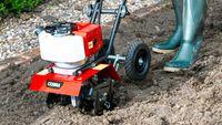 A Cobra tiller being used on a patch of soil