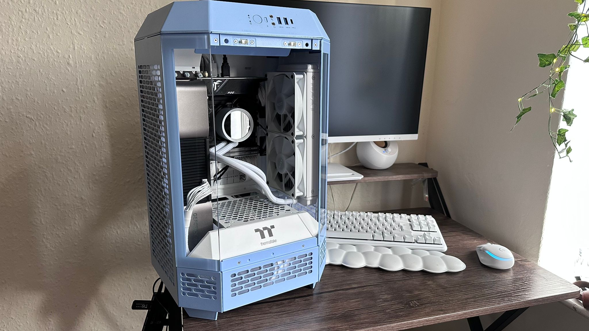 Thermaltake Tower 250 on a desk with accessories