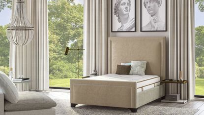 The Saatva Latex Hybrid Mattress on a bed beneath classical paintings against windows with a garden view.