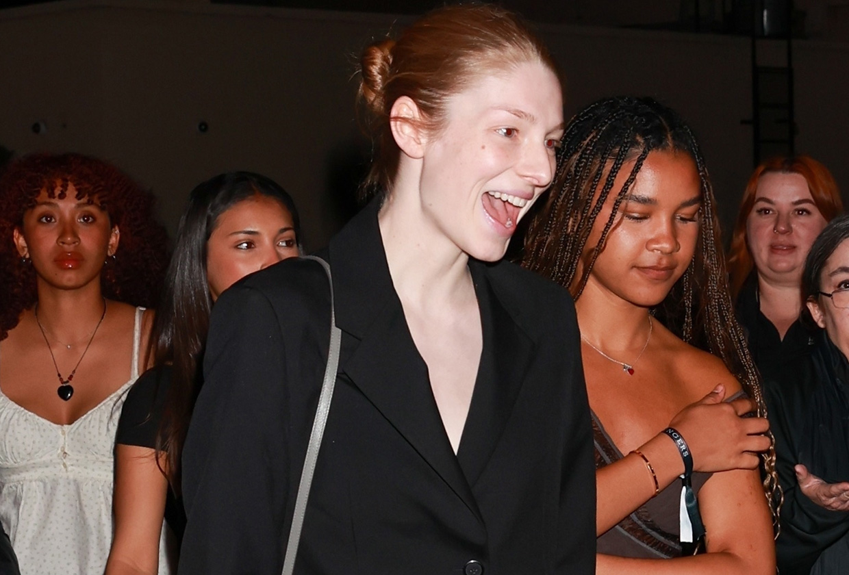 Hunter Schafer wearing a black suit and green satin Prada pumps to the Challengers L.A. premiere after-party.