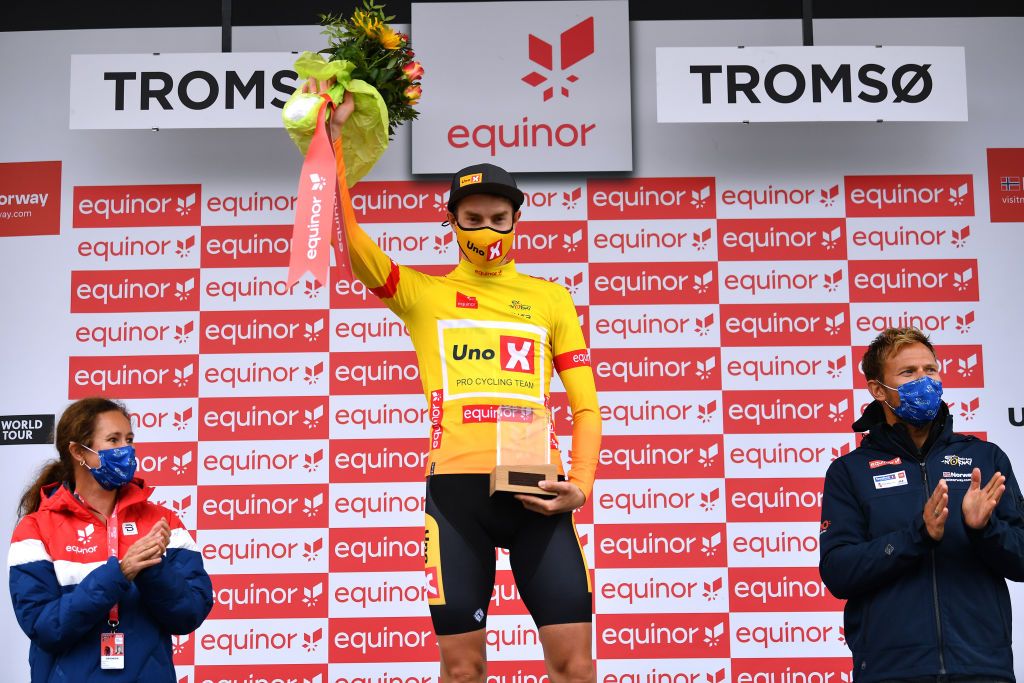 TROMSO NORWAY AUGUST 05 Markus Hoelgaard of Norway and UNO X Pro Cycling Team Yellow Leader Jersey celebrates at podium during the 8th Arctic Race Of Norway 2021 Stage 1 a 1425km stage from Troms to Troms ArcticRace on August 05 2021 in Tromso Norway Photo by Stuart FranklinGetty Images