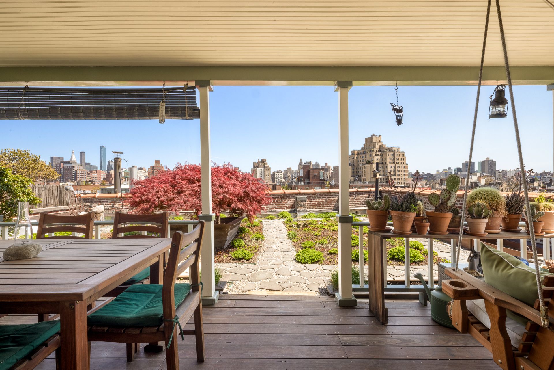 Details of the penthouse at 719 Greenwich Street, showing a characterful home with lots of wood, exposed brick, and fabulous views