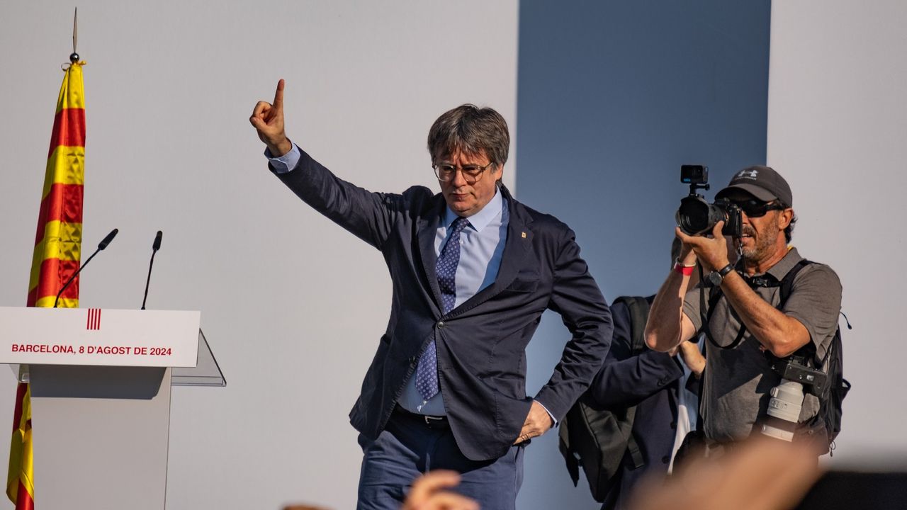 Puigdemont addresses supporters on a stage beside the Arc de Triomf monument, just outside the Ciutadella park where the Catalan parliament is located 