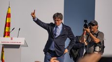 Puigdemont addresses supporters on a stage beside the Arc de Triomf monument, just outside the Ciutadella park where the Catalan parliament is located 