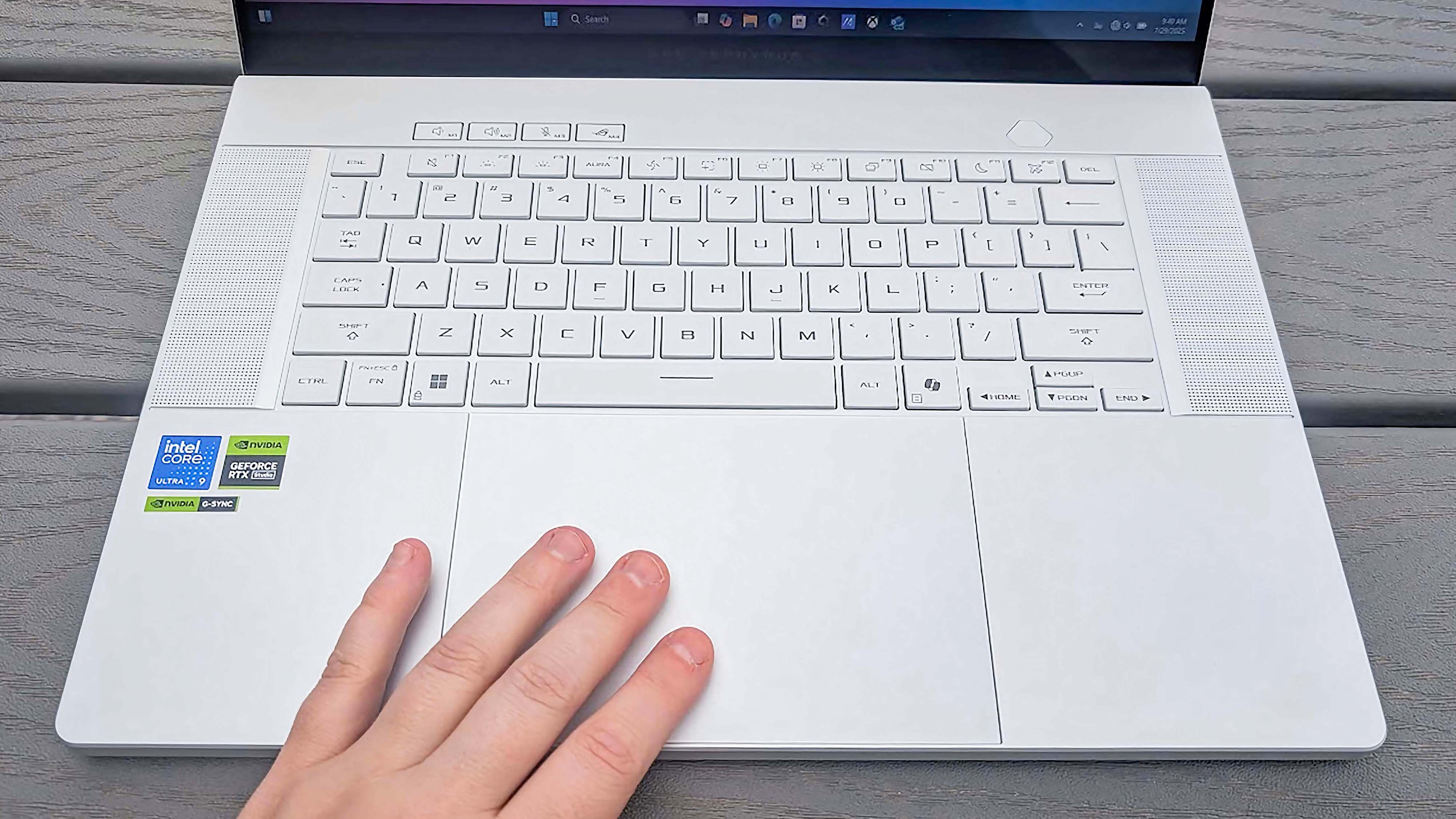 A hand resting on the touchpad of the ATheSUS ROG Zephyrus G16 (GU605C, 2025)
