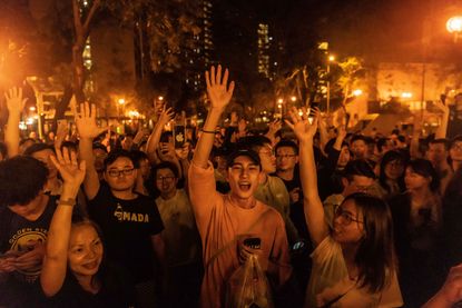 Voters celebrate a pro-Beijing candidate's loss.