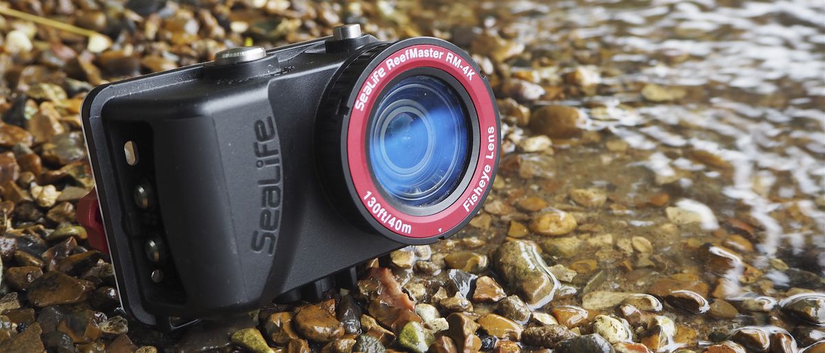 SeaLife ReefMaster RM-4K waterproof camera on a stony waterside