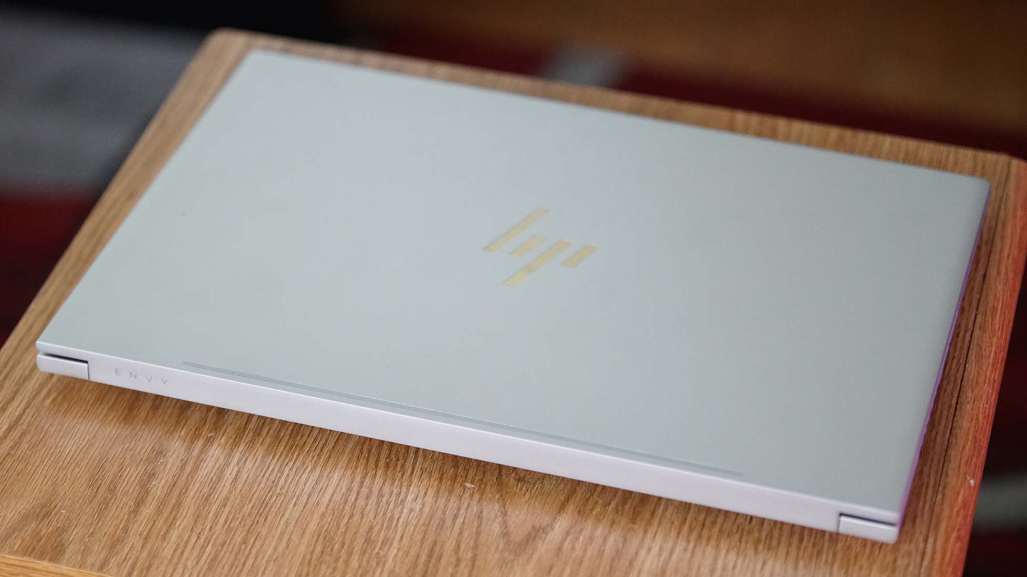 An HP Envy 16 on a wooden table