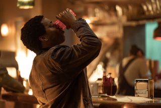 Chiwetel Ejiofor as Faraday guzzling water in The Man Who Fell to Earth