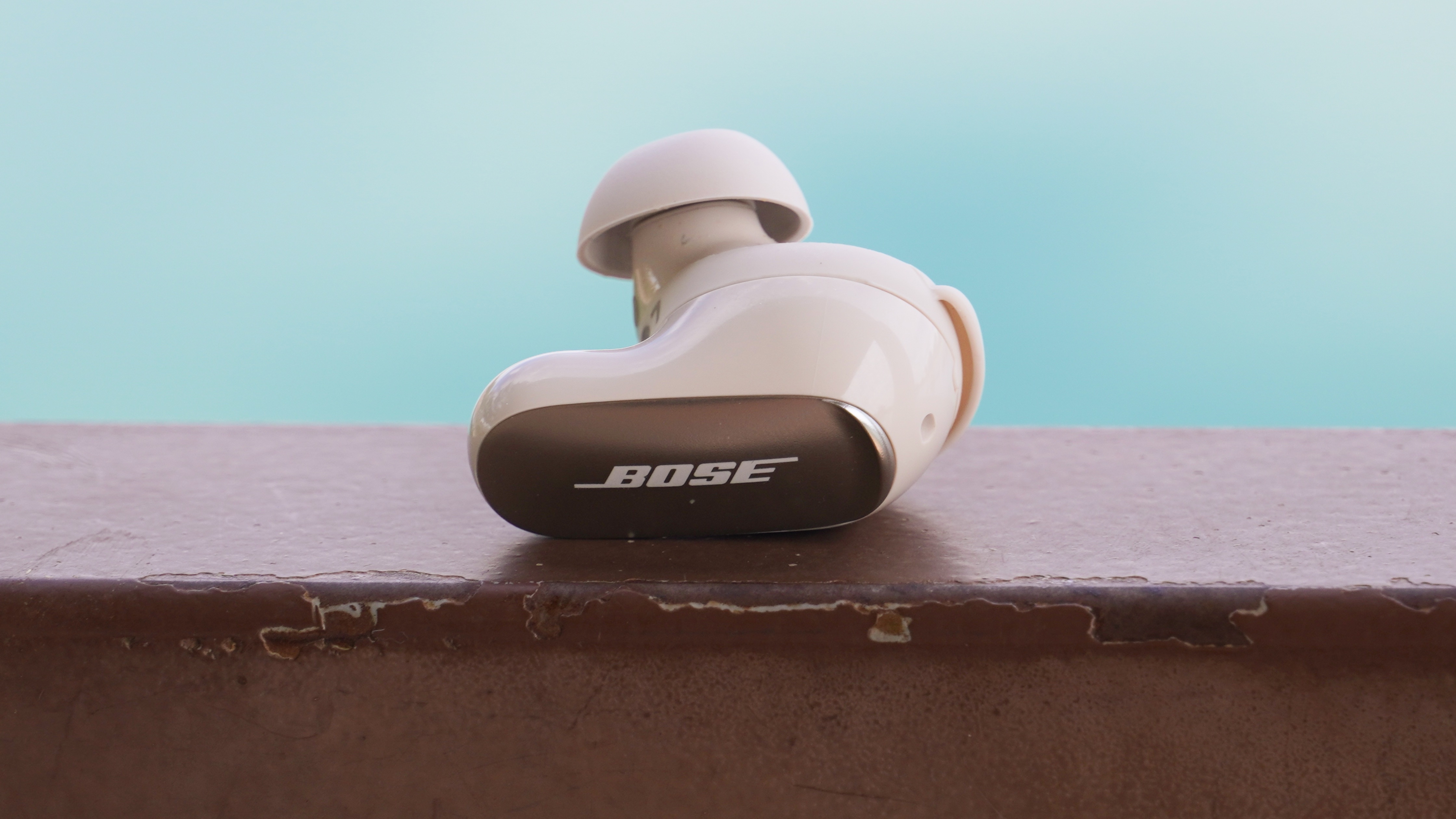 The Bose QuietComfort Ultra Gen 2 earbuds showing a single earbud with the Bose logo facing outward.