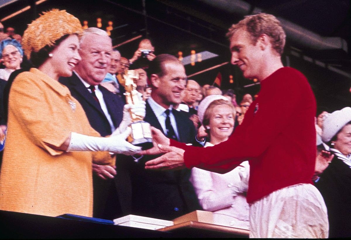 England captain Bobby Moore receives the Jules Rimet trophy from Queen Elizabeth II after England's victory over West Germany in the 1966 World Cup final