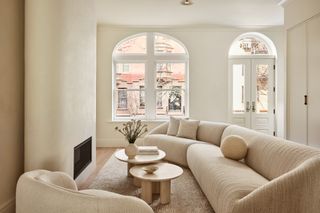 A neutral living room that uses the sofa as a zoning device