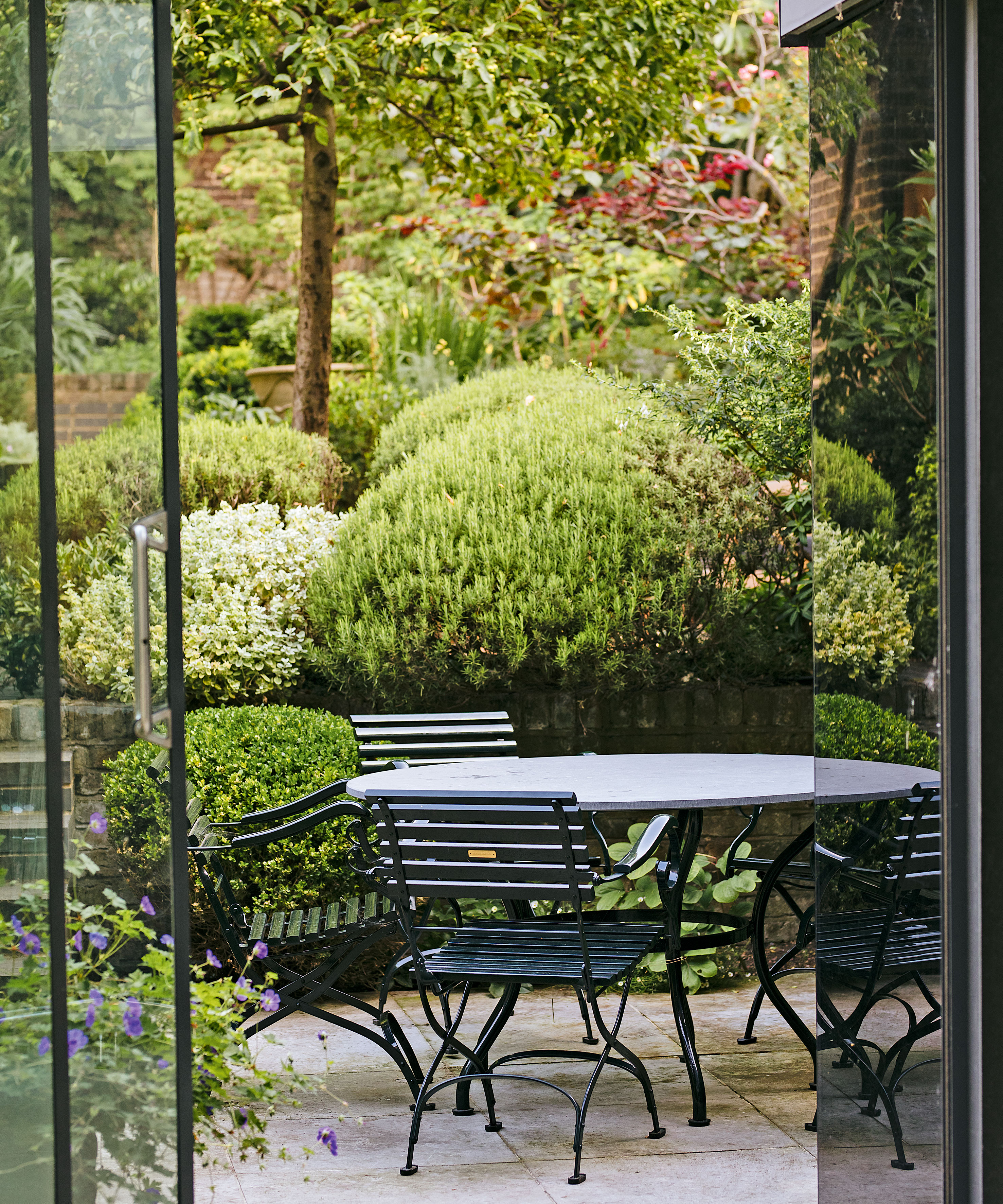 small sloping terraced garden with lower seating area