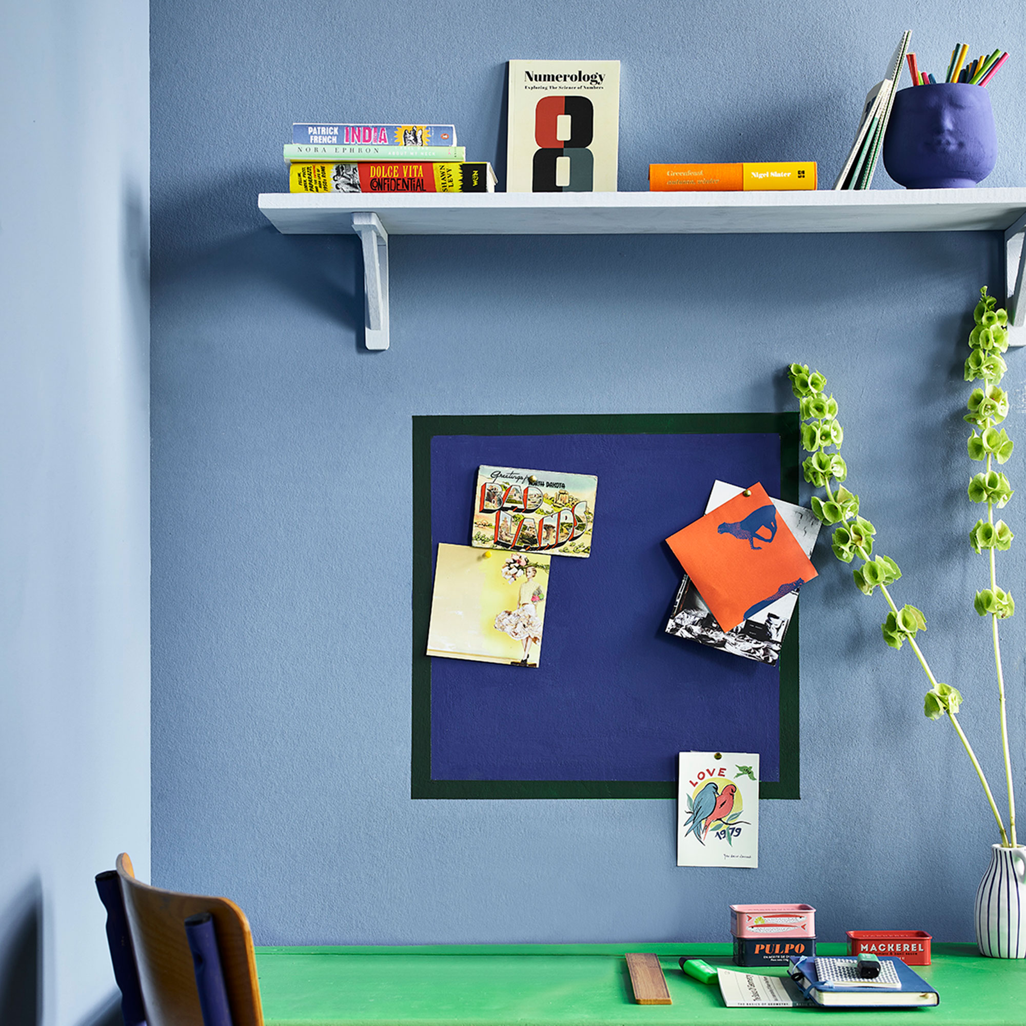 Blue home office with green desk