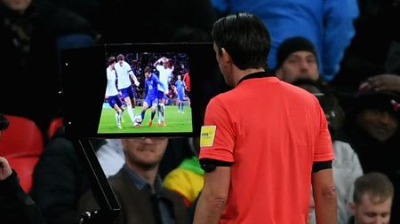 A referee checks VAR monitor 