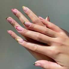 Polka dot nails with multi-coloured french tips