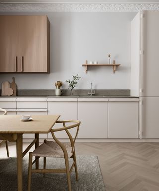 A neutral ikea kitchen with wood flooring and gray countertops