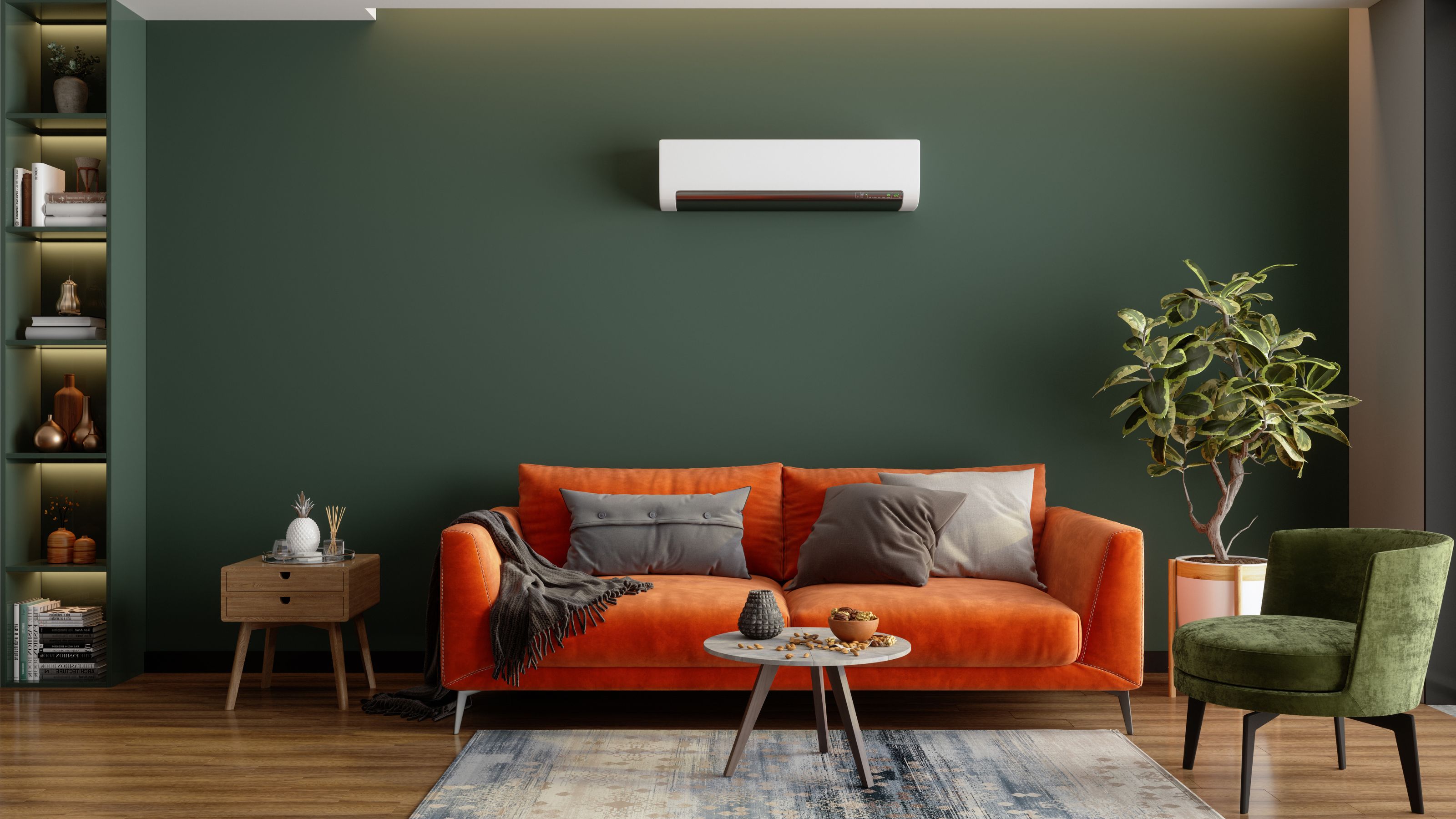 Air conditioning unit mounted on a green wall above an orange sofa with grey cushions and a small green accent chair to the side