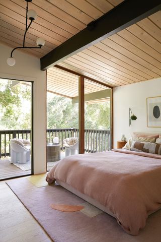 a bedroom in a midcentury home with a balcony