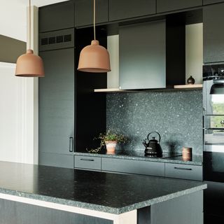 Dark grey modern kitchen with dark grey worktops and dark grey splashbacks