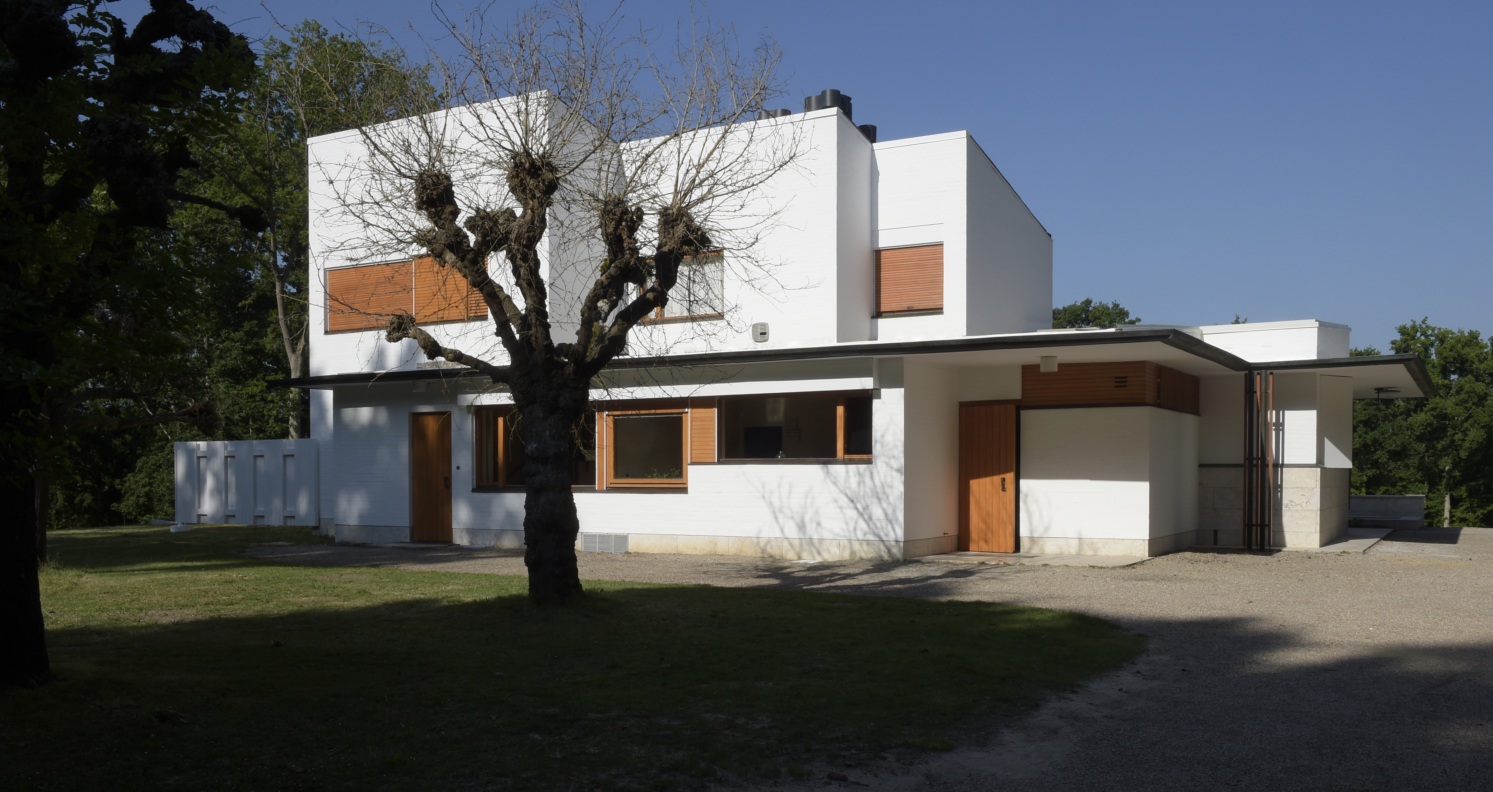 the white, clear, crisp and restored Maison Louis Carre by Alvar Aalto against blue skies