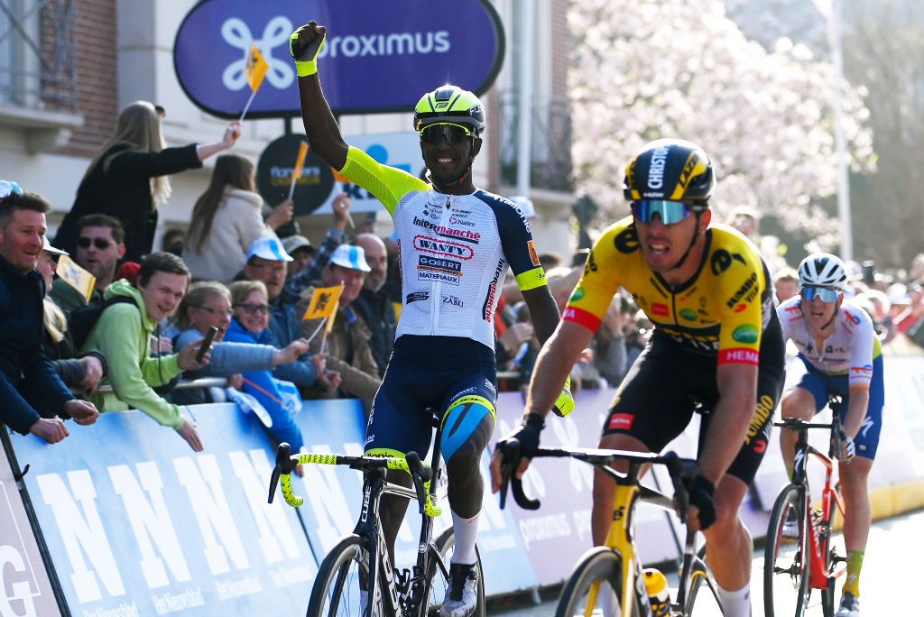 WEVELGEM BELGIUM MARCH 27 Biniam Hailu Girmay of Eritrea and Team Intermarch Wanty Gobert Matriaux celebrates winning ahead of Christophe Laporte of France and Team Jumbo Visma and Dries Van Gestel of Belgium and Team Total Energies during the 84th GentWevelgem in Flanders Fields 2022 Mens Elite a 2488km one day race from Ypres to Wevelgem GWE22 WorldTour on March 27 2022 in Wevelgem Belgium Photo by Tim de WaeleGetty Images