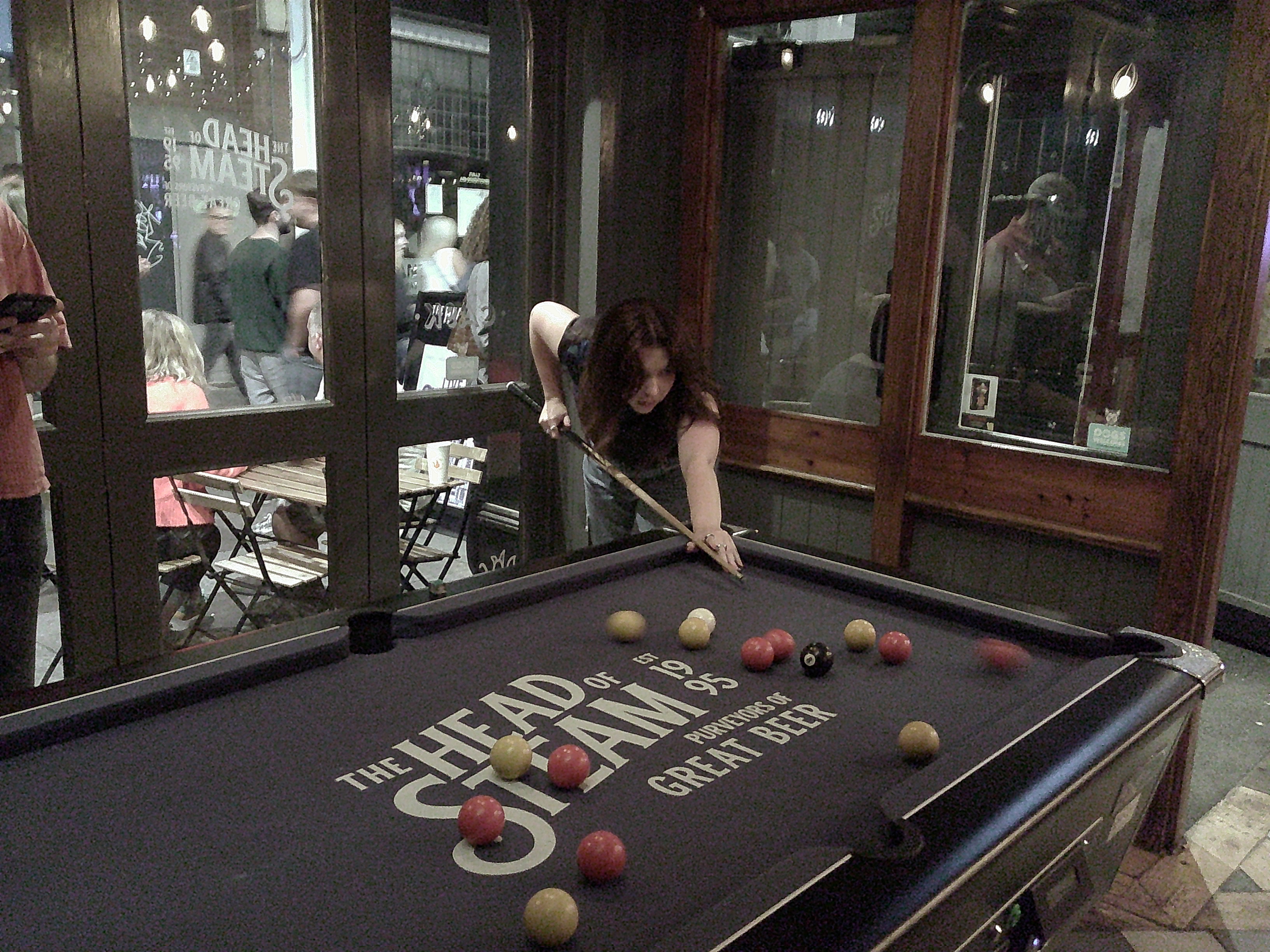 Image of woman playing pool taken with the Camp Snap Screen-Free Digital Camera. 