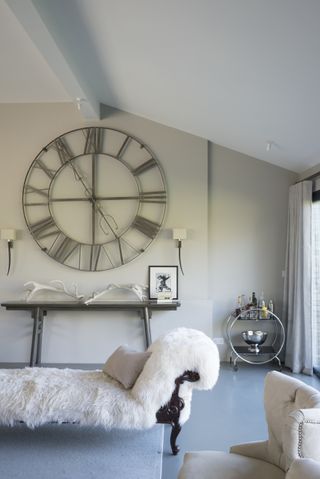 A living room with a large wall clock