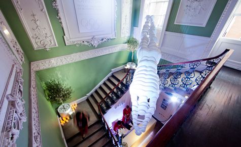 A kinetic diver installation, designed for Omega by Wootton &amp; Dawe, is suspended over the staircase at Omega House and points to the brand&#039;s great diving watch heritage